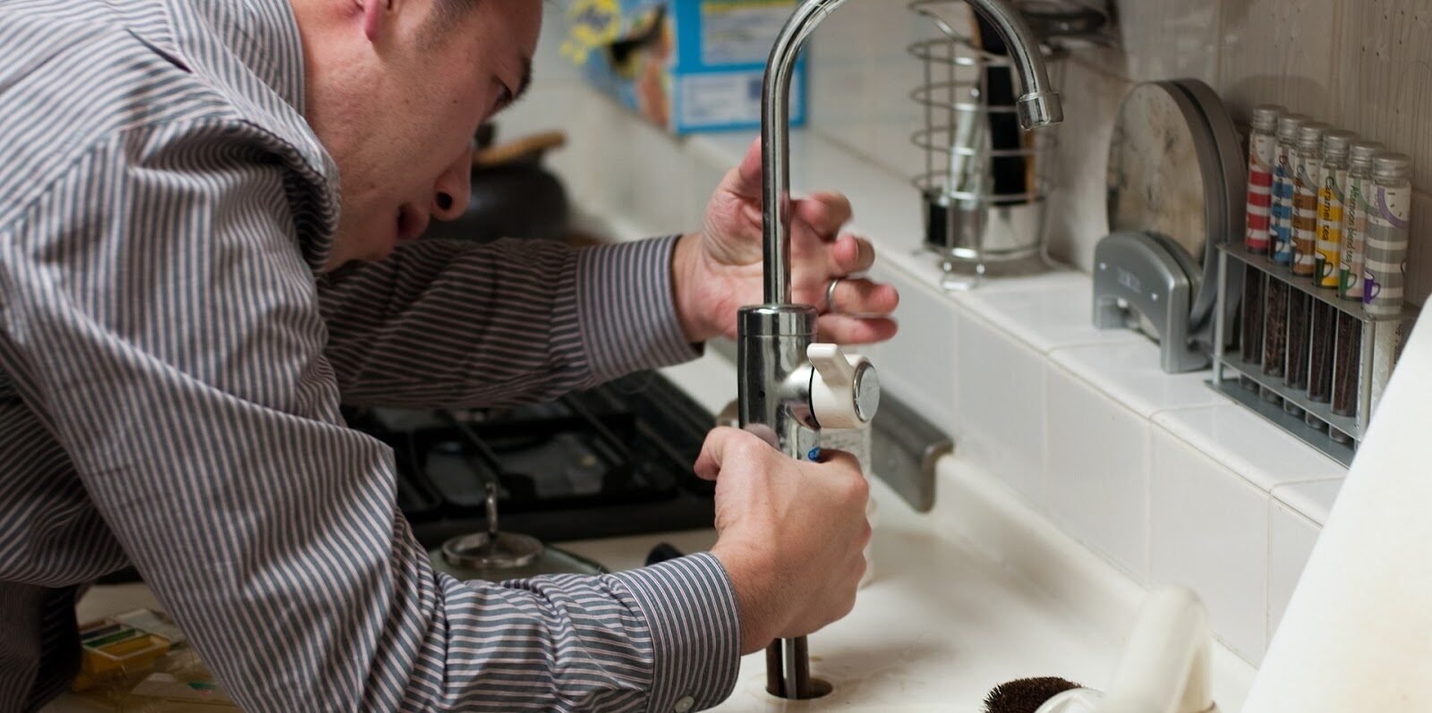 handyman fixing the kitchen sink