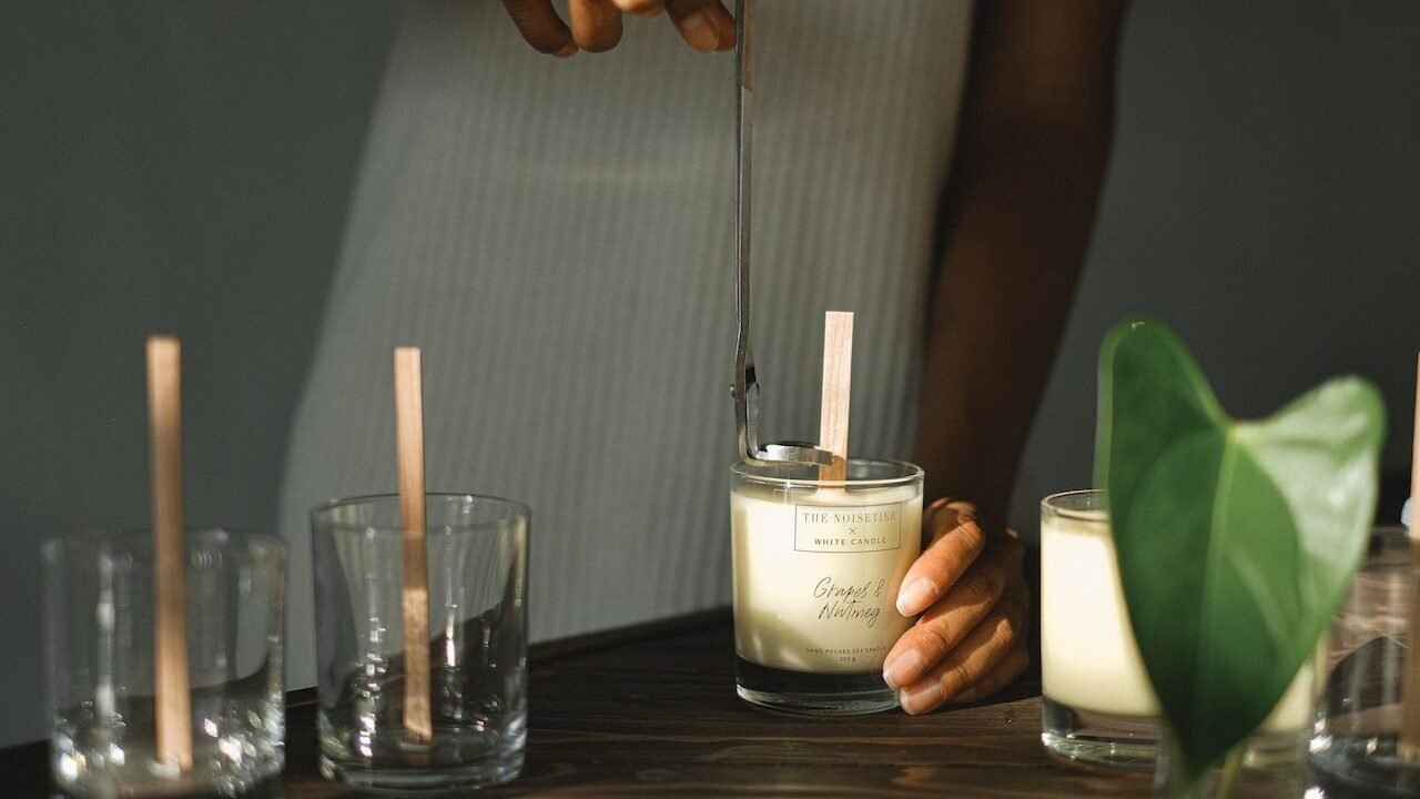 A woman creating a scented candle.